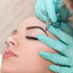 A skin care specialist performing microblading