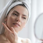 Woman examining aging skin